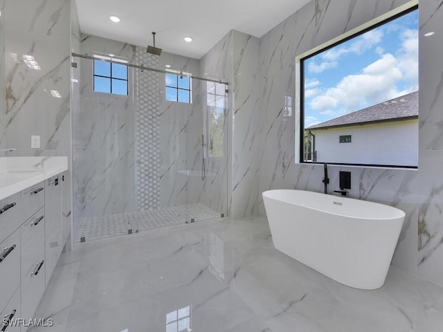 bathroom featuring vanity, tile walls, and shower with separate bathtub