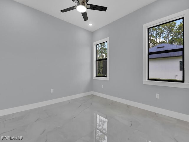 empty room with ceiling fan and a healthy amount of sunlight