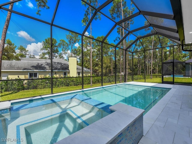 view of pool with a patio area, an in ground hot tub, a lawn, and glass enclosure