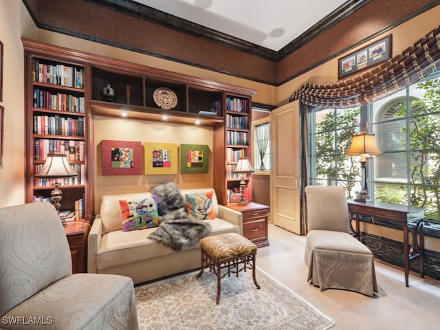 sitting room featuring light colored carpet and ornamental molding