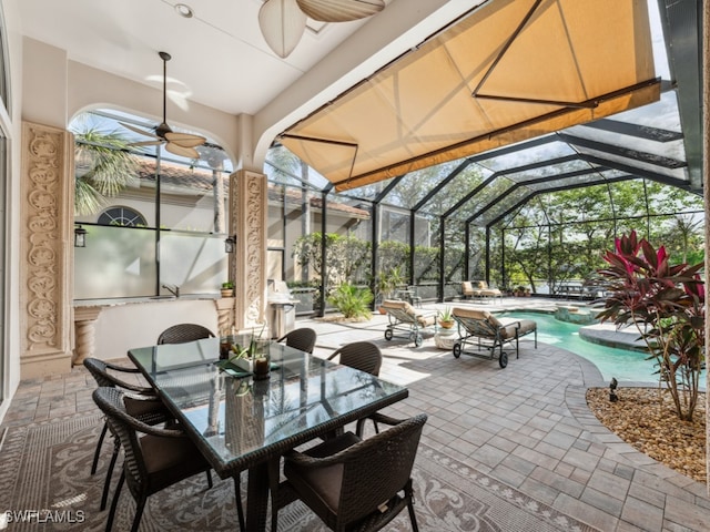 sunroom featuring ceiling fan, lofted ceiling, and a swimming pool