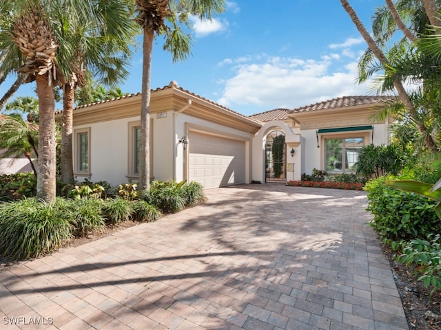 mediterranean / spanish-style house with a garage