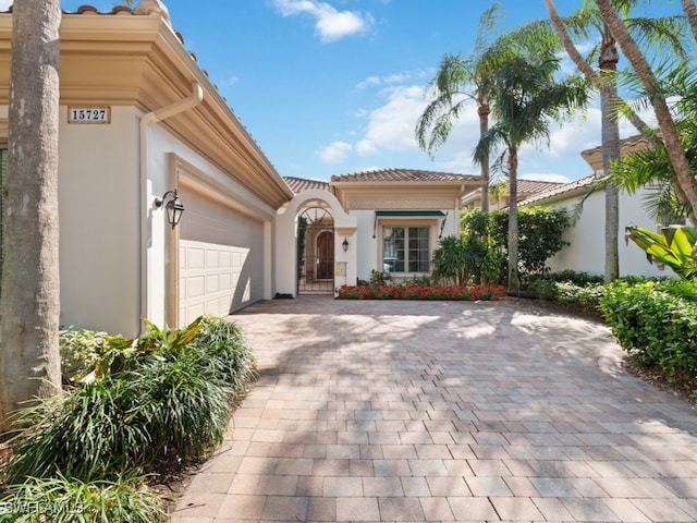 mediterranean / spanish-style house with a garage