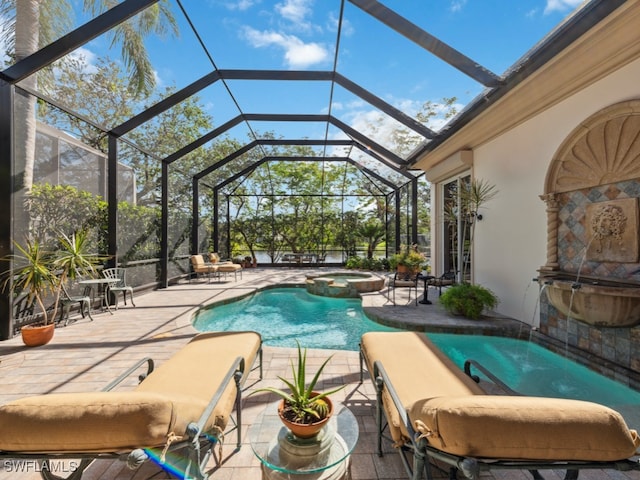 view of swimming pool with an in ground hot tub, glass enclosure, and a patio area