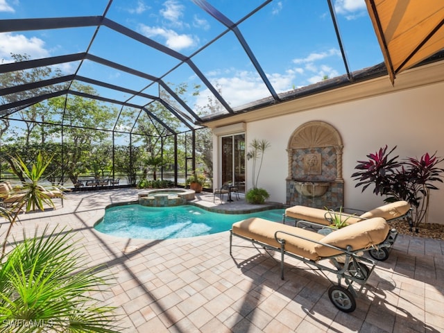 view of pool featuring glass enclosure, a patio area, and an in ground hot tub