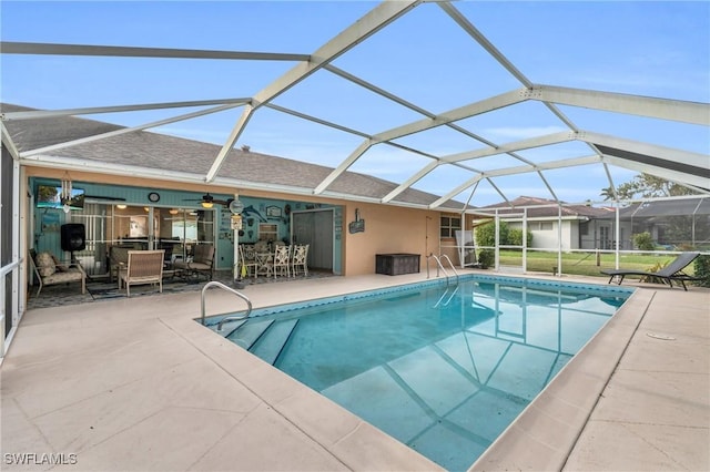 view of swimming pool with a patio area and a lanai