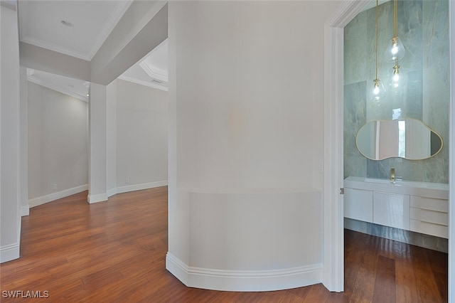 hallway with crown molding and hardwood / wood-style floors