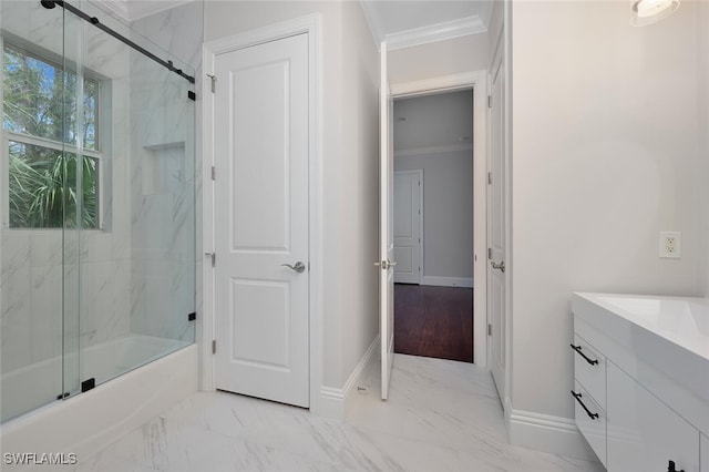 bathroom with vanity, ornamental molding, and enclosed tub / shower combo