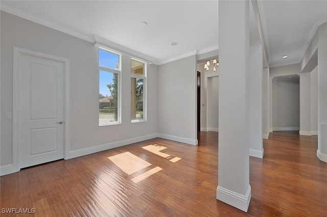 unfurnished room with ornamental molding, hardwood / wood-style flooring, and a notable chandelier