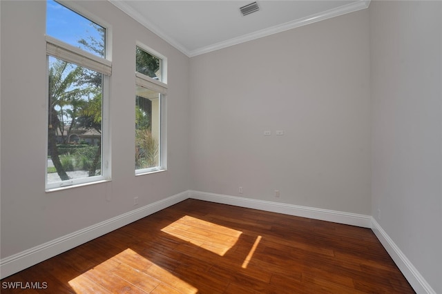 empty room with ornamental molding, wood-type flooring, and a wealth of natural light