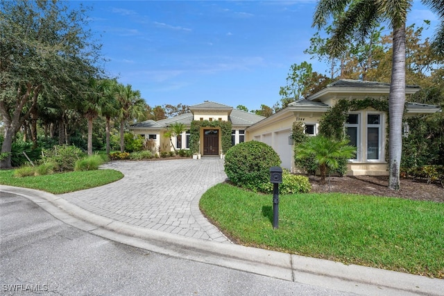 view of front of home with a garage and a front yard