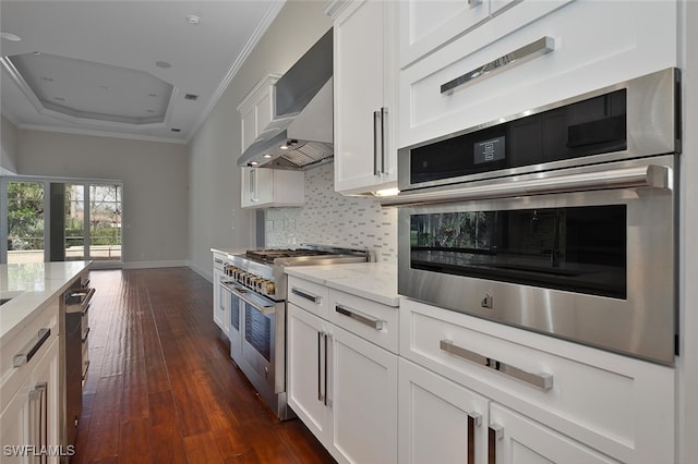 kitchen featuring ornamental molding, stainless steel appliances, white cabinetry, and light stone countertops