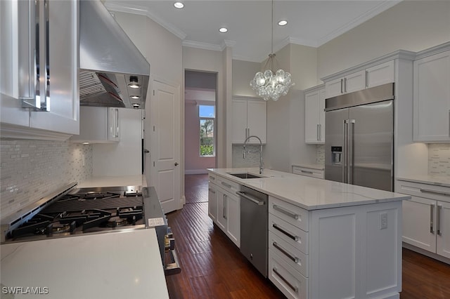 kitchen featuring sink, stainless steel appliances, an island with sink, and white cabinets