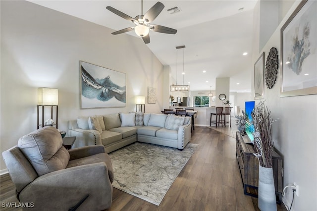 living room with dark wood-type flooring and ceiling fan