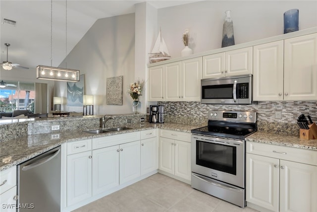 kitchen with appliances with stainless steel finishes, white cabinetry, and sink