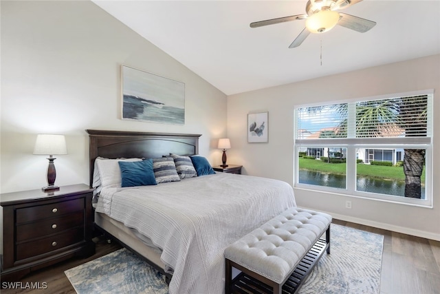 bedroom with dark wood-type flooring, ceiling fan, and vaulted ceiling