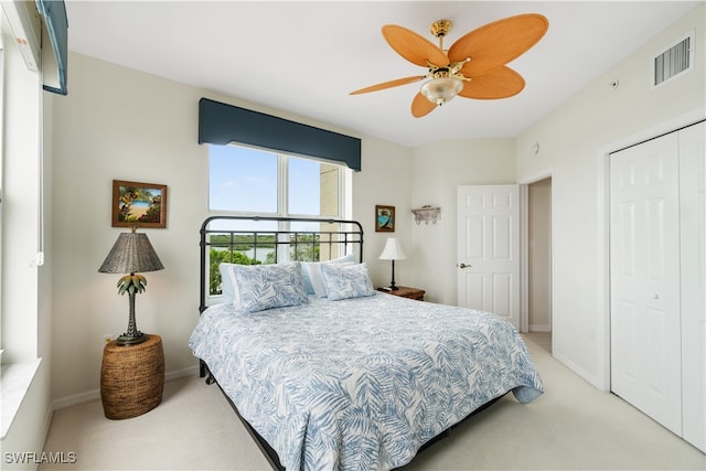 carpeted bedroom featuring a closet and ceiling fan