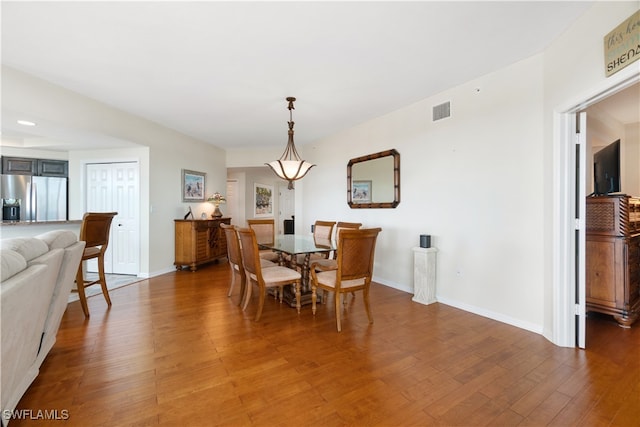 dining space with hardwood / wood-style flooring