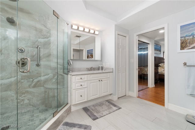 bathroom featuring vanity, hardwood / wood-style flooring, and an enclosed shower