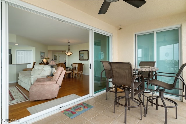 sunroom / solarium featuring ceiling fan