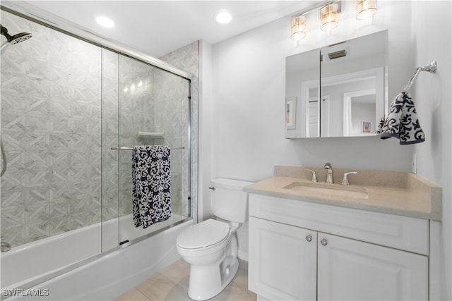 full bathroom featuring bath / shower combo with glass door, toilet, vanity, and tile patterned floors