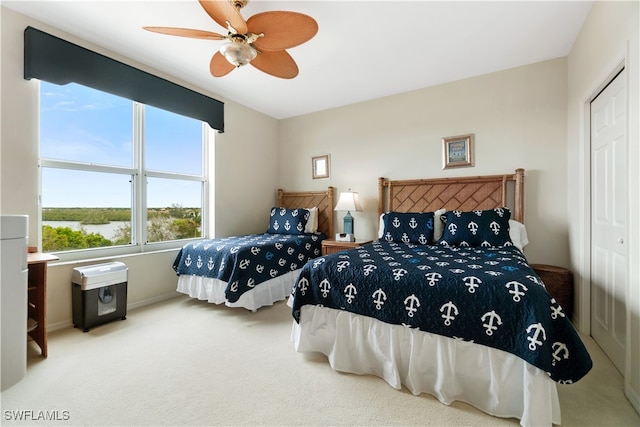 carpeted bedroom with a closet and ceiling fan