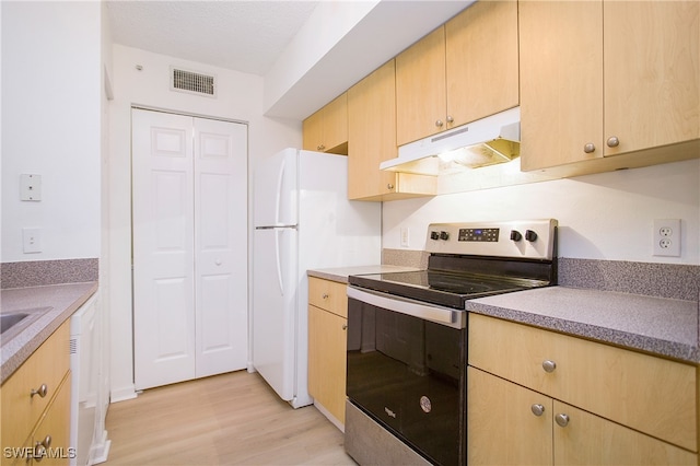 kitchen featuring light brown cabinets, a textured ceiling, light wood-type flooring, and white appliances