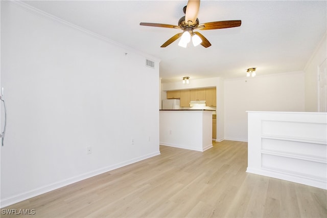 spare room featuring ceiling fan, ornamental molding, and light hardwood / wood-style floors