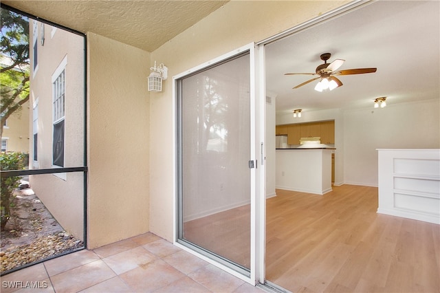 entrance to property with ceiling fan