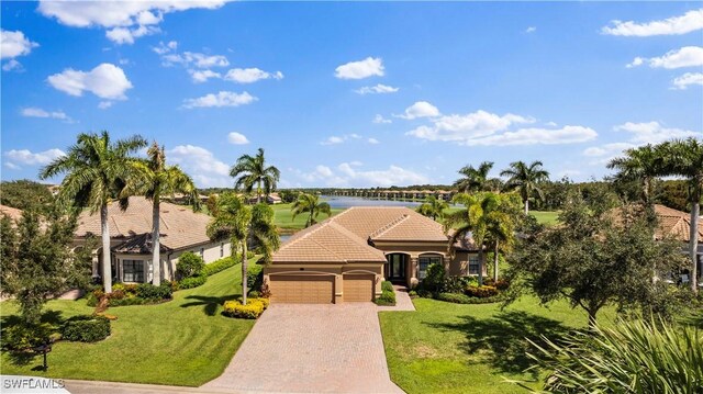 mediterranean / spanish house featuring a front lawn and a garage