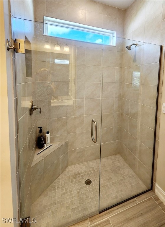 bathroom with a shower with door