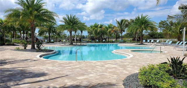 view of swimming pool featuring a community hot tub and a patio