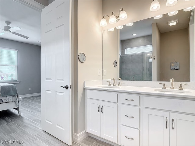 bathroom featuring ceiling fan, vanity, and walk in shower