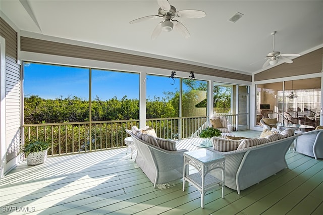 sunroom with lofted ceiling and ceiling fan