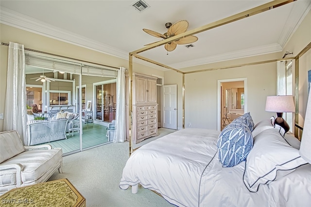 bedroom with multiple windows, crown molding, ceiling fan, and light colored carpet