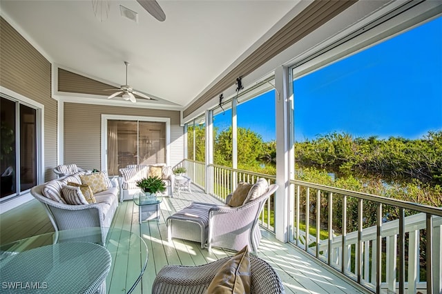 sunroom / solarium with ceiling fan and vaulted ceiling