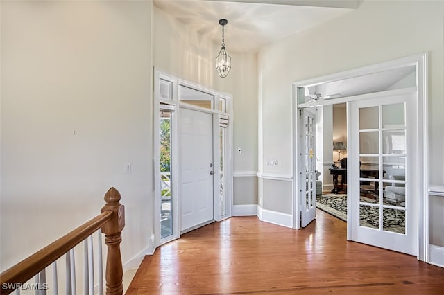 foyer entrance with a chandelier and hardwood / wood-style flooring