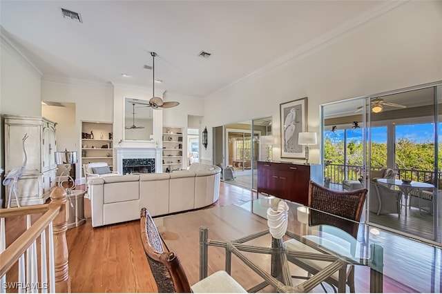 dining space featuring crown molding, ceiling fan, and light hardwood / wood-style flooring