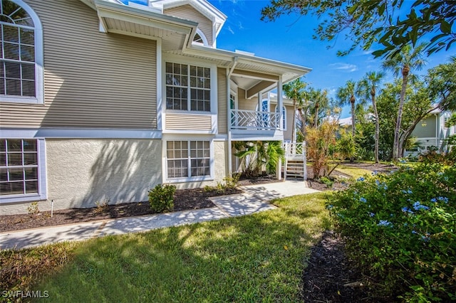 view of side of home featuring a yard