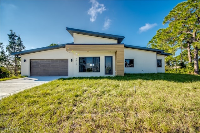 view of front of house with a front yard and a garage