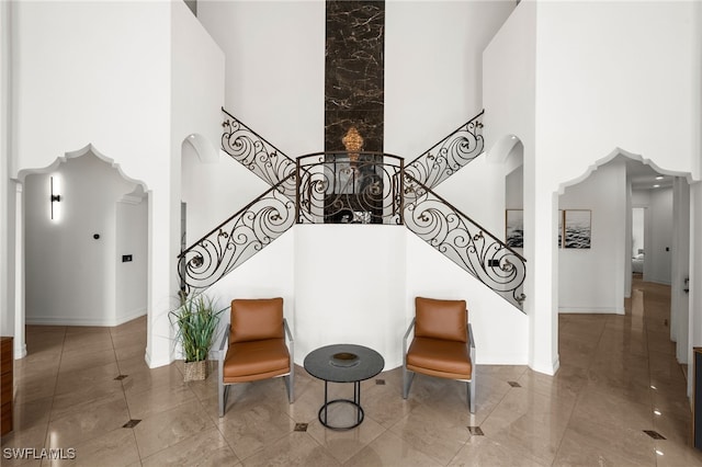 staircase featuring a towering ceiling