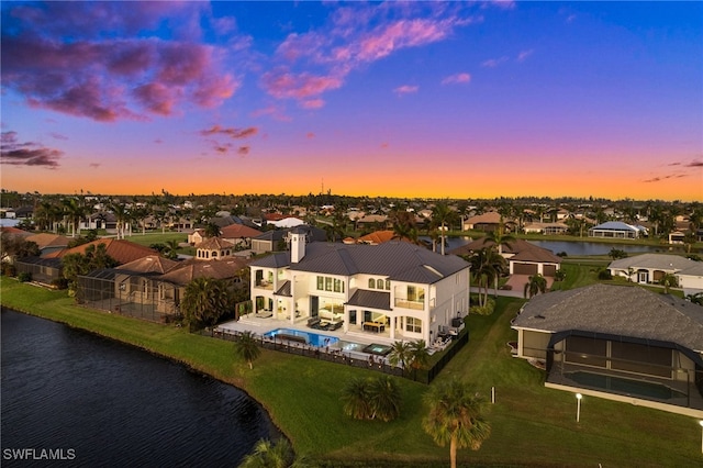 aerial view at dusk with a water view