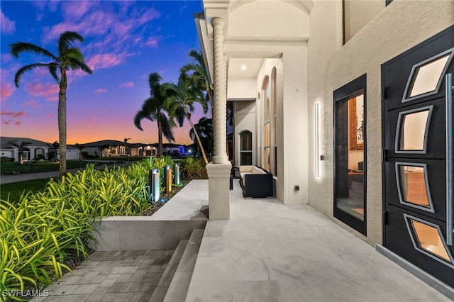 view of patio terrace at dusk