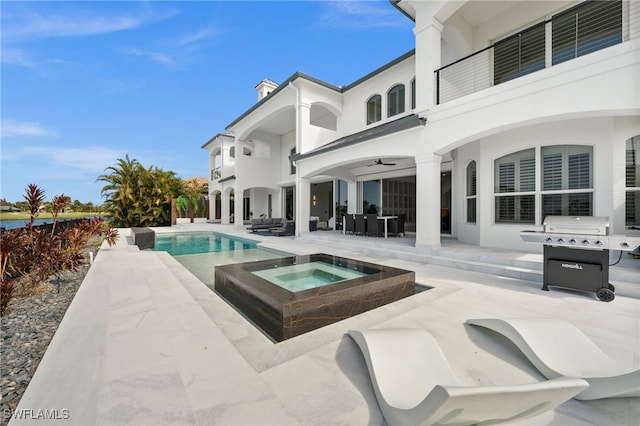 view of swimming pool with an in ground hot tub, a grill, and a patio area