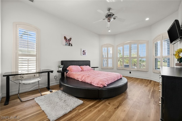 bedroom featuring ceiling fan and light hardwood / wood-style flooring