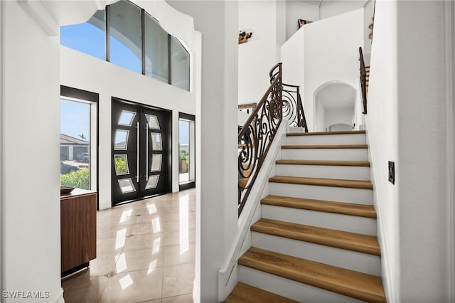 tiled foyer entrance featuring a high ceiling