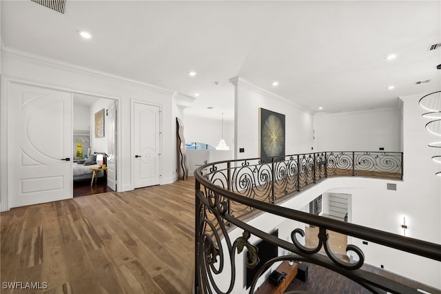 hallway with crown molding and hardwood / wood-style flooring