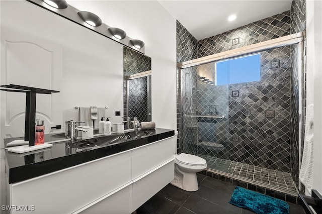 bathroom featuring tile patterned flooring, vanity, a shower with door, and toilet