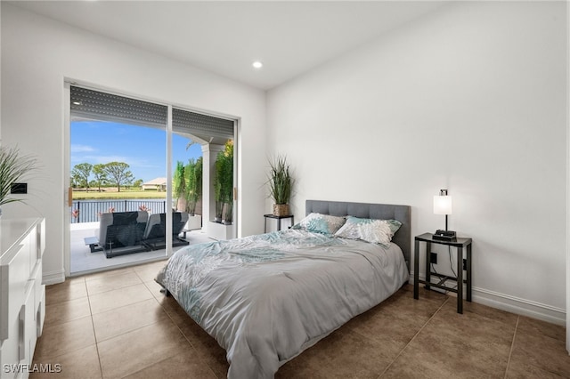 bedroom featuring a water view and access to outside