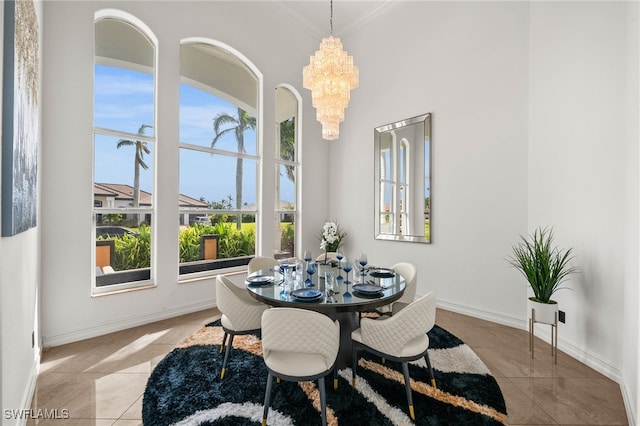 tiled dining space with a notable chandelier and crown molding